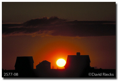 Three barns, orange ball of fire