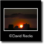 Three barns, orange glowing sunset